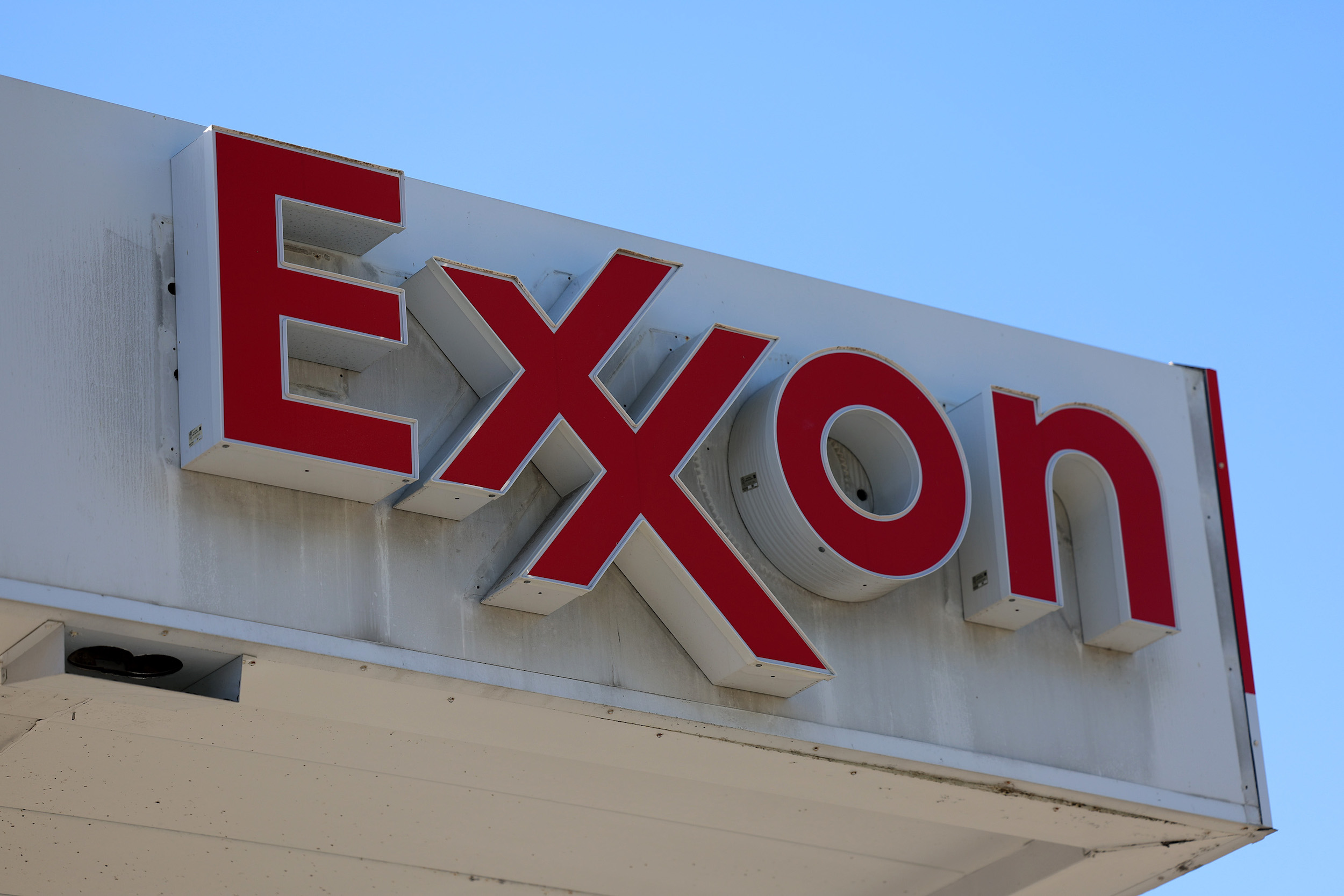 A close-up of a red Exxon sign at a gas station in Florida.